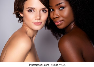 Portrait of two attractive alluring women bonding flawless skin complexion visage wellness vitality isolated over grey pastel color background