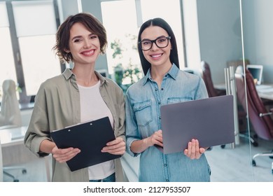 Portrait of two attractive clever smart cheerful leaders executive managers reading documents start-up at workplace workstation indoors - Shutterstock ID 2127953507