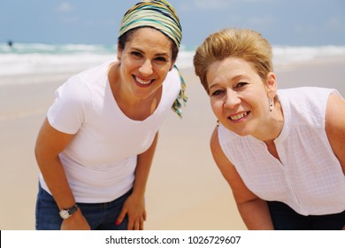 Portrait Of Two Beautiful 45 Years Old Women Walking On Seaside