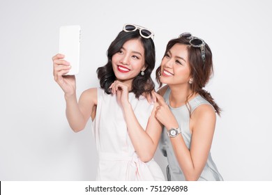 Portrait Of Two Beautiful Asian Fashionable Women Taking Selfie