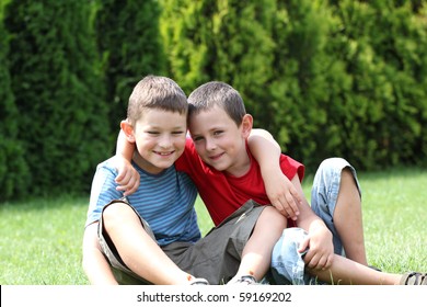 Portrait of two boys, siblings, brothers and best friends smiling. Friends hugging.