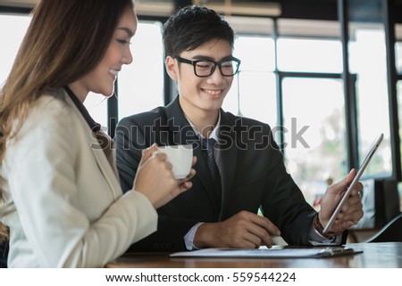 portrait of two business people discussing new project in coffee shop