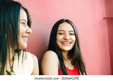 portrait of two cheerful young women smiling while talking. friendship and dental health concept. - Powered by Shutterstock