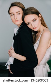 portrait of two different twins sisters. fine art fashion portrait of two not similar to each other twins. woman twins. adults female twins. men-like sister and  feminine sister. Nordic style 