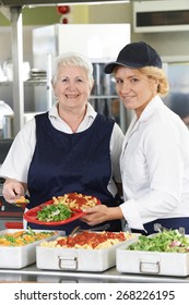 Portrait Of Two Dinner Ladies In School Cafeteria