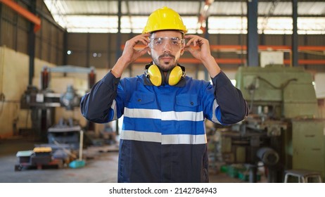 Portrait Of Two Engineers Standing In The CNC Factory. Remove Safety Glasses In The Production Line With Smile. High Technology Of Machine. Industrial And Good Workplace Concept