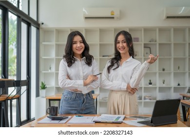Portrait of two entrepreneurs young Asian woman, business woman arms crossed on modern office - Shutterstock ID 2208327143