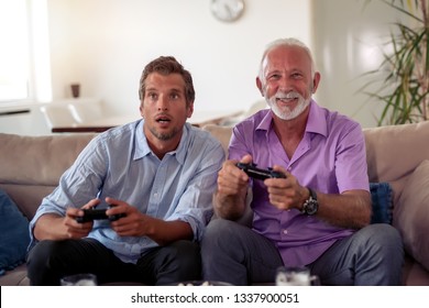 Portrait of two excited men playing video game at home. - Shutterstock ID 1337900051