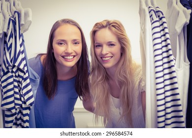 Portrait Of Two Friends Looking Through The Clothes Rack