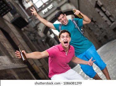 Portrait of two friends who are drinking beer after football match in Barcelona. - Shutterstock ID 1086081299