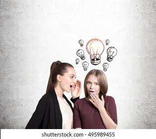 Portrait of two girlfriends gossiping. One of them is surprised and has an idea. Concept of intrigues and plot twists in our lives - Shutterstock ID 495989455