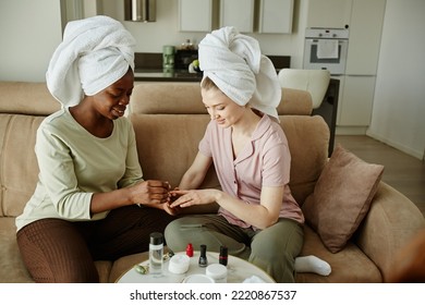 Portrait of two girls with towels doing manicure while enjoying self care day at home - Powered by Shutterstock