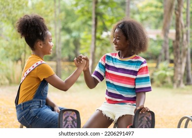 Portrait Of Two Happy African American Child Girl Smiling And Hold Hands Together At The Playground