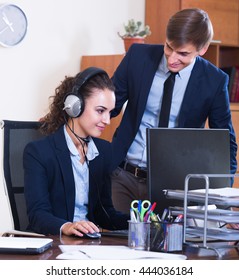 Portrait Of Two Happy Help Line Salesperson At Workplace