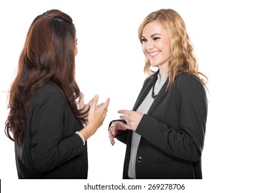 A portrait of two happy young businesswoman talking, isolated