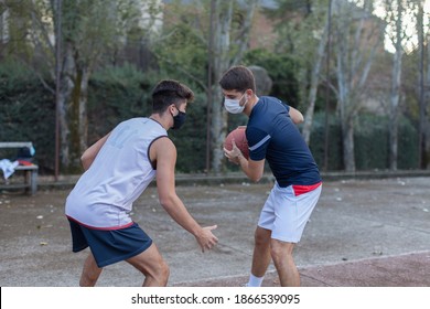 Portrait of two hos teenage brothers playing basketball at sunset - Powered by Shutterstock