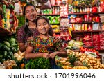 
Portrait of two indigenous girls looking at the camera, in a grocery store in Guatemala.