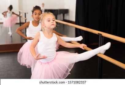 Portrait Of Two Little Ballerinas Practicing Choreography In Dance Hall