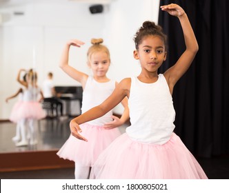 Portrait Of Two Little Ballerinas Practicing Choreography In Dance Hall