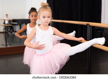 Portrait Of Two Little Ballerinas Practicing Choreography In Dance Hall