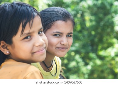 A portrait of two little young rural Indian village girls sitting. Selective focus