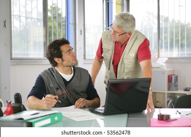 Portrait Of Two Men In Front Of A Laptop Computer In An Office