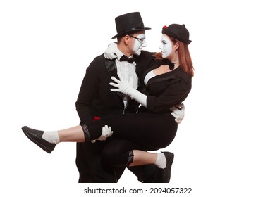Portrait of two mime artists performing, isolated on white background. Woman is sitting on the mans knee. Symbol of close friendship, relations, trust relationship