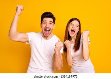 Portrait of two nice attractive lovely charming cheerful cheery people having fun lottery win winner best luck lucky isolated over vivid shine bright yellow background - Shutterstock ID 1384189973