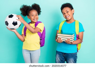 Portrait of two nice cheerful friends friendship studying having fun isolated over bright teal turquoise color background