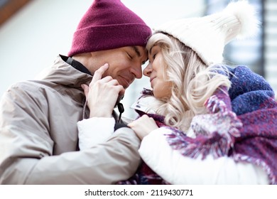 Portrait of two people couple fair-haired woman and man crossing hands together looking at each other. Calm comfortable bounding relationship. Close up. Blur smooth background. Outdoor
