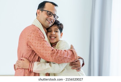 Portrait two people of happy single Indian father, teenage handsome son hugging with warmth, love, wearing traditional clothes, smiling in cozy indoor home. Family, Education, Lifestyle Concept - Shutterstock ID 2156520027