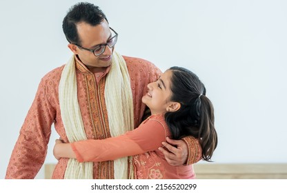 Portrait Two People Of Happy Single Indian Father, Cute Little Daughter Girl Hugging With Warmth, Love, Wearing Traditional Clothes, Smiling In Cozy Indoor Home. Family, Education, Lifestyle Concept