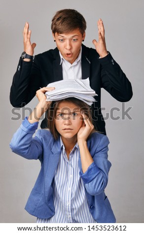 portrait of two people. Problems in their business relationships. The Chief loads the subordinate