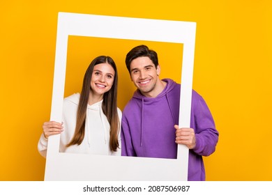 Portrait of two persons hold paper photo frame toothy smile look camera isolated on yellow color background - Shutterstock ID 2087506987