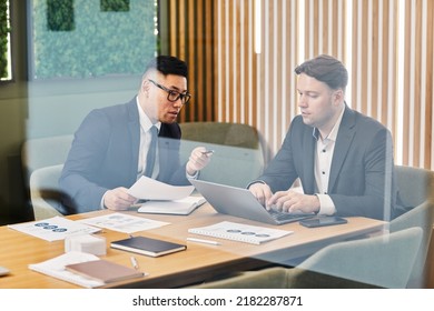 Portrait Of Two Professional Business People Meeting In Designer Office Lounge Behind Glass Wall, Copy Space