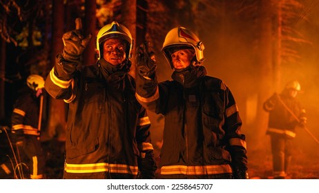 Portrait of Two Professional Firefighters Standing in a Forest, Discussing the Situation Report During a Wildland Fire. Female Superintendent Talking with African American Squad Leader. - Shutterstock ID 2258645707