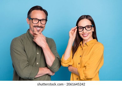Portrait of two satisfied cheerful persons look camera toothy smile isolated on blue color background
