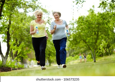 Portrait of two senior females running outdoors - Powered by Shutterstock