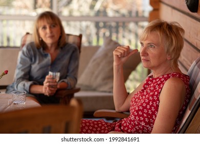 Portrait Of Two Sisters Women 55 Years On Patio Wooden House