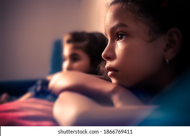 Portrait Of Two Small Girls Watching TV - With A Shallow Depth Of Field