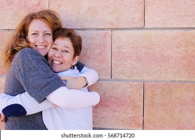 Portrait Of Two Smiling 40 Years Old Women Outdoors