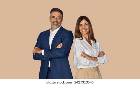 Portrait of two smiling mature Latin business man, European business woman standing arms crossed isolated on beige background. Diverse colleagues, group team of confident professional business people - Powered by Shutterstock