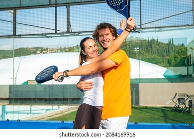 Portrait of two smiling sportsman's posing on padel court outdoor with rackets - Padel players looking at camera and embracing after win a padel match - Powered by Shutterstock