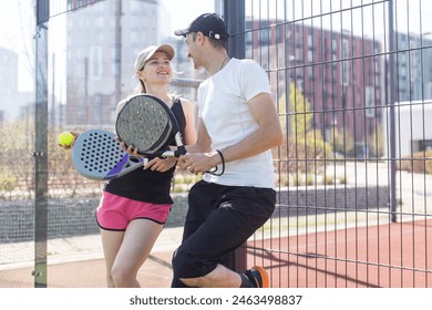 Portrait of two smiling sportsman's posing on padel court outdoor with rackets - Padel players  - Powered by Shutterstock