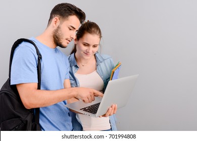 Portrait Of Two Student Male And Female On Grey Plain Background With Copyspace