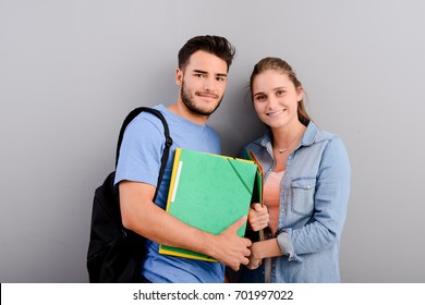 Portrait Of Two Student Male And Female On Grey Plain Background With Copyspace