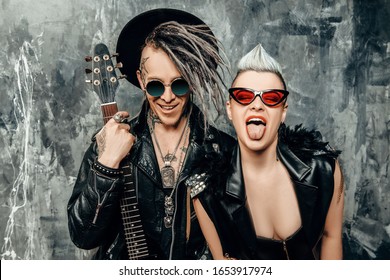 A portrait of two stylish punk people. Modern men fashion, rock musicians.