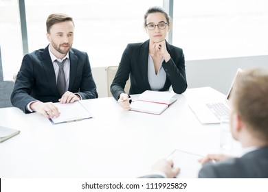 Portrait Of Two Successful Business People, Man And Woman,  Talking To Partner Sitting Across Meeting Table In Conference Room, Copy Space