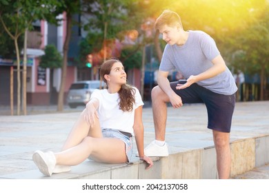 Portrait Of Two Teenage Friends Chatting Outdoors In Town