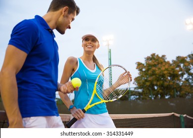 Portrait of a two tennis player talking outdoors - Powered by Shutterstock